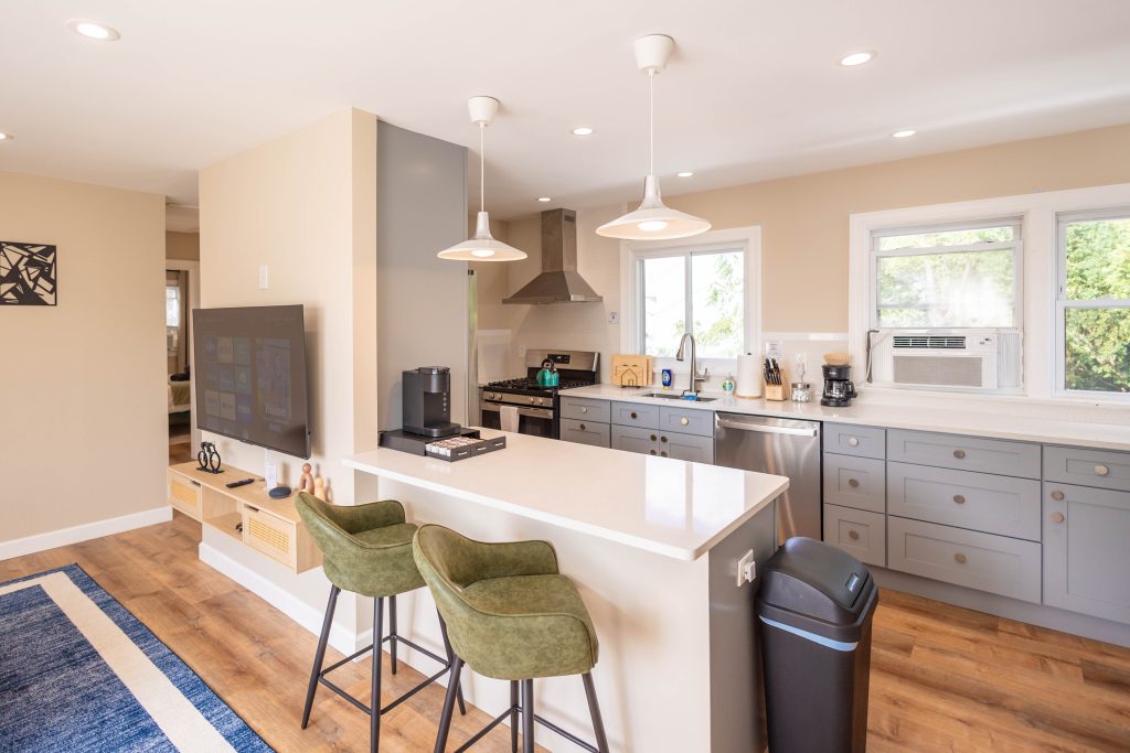 A bright and modern kitchen featuring a spacious counter, and a polished stainless steel sink ideal for culinary activities.