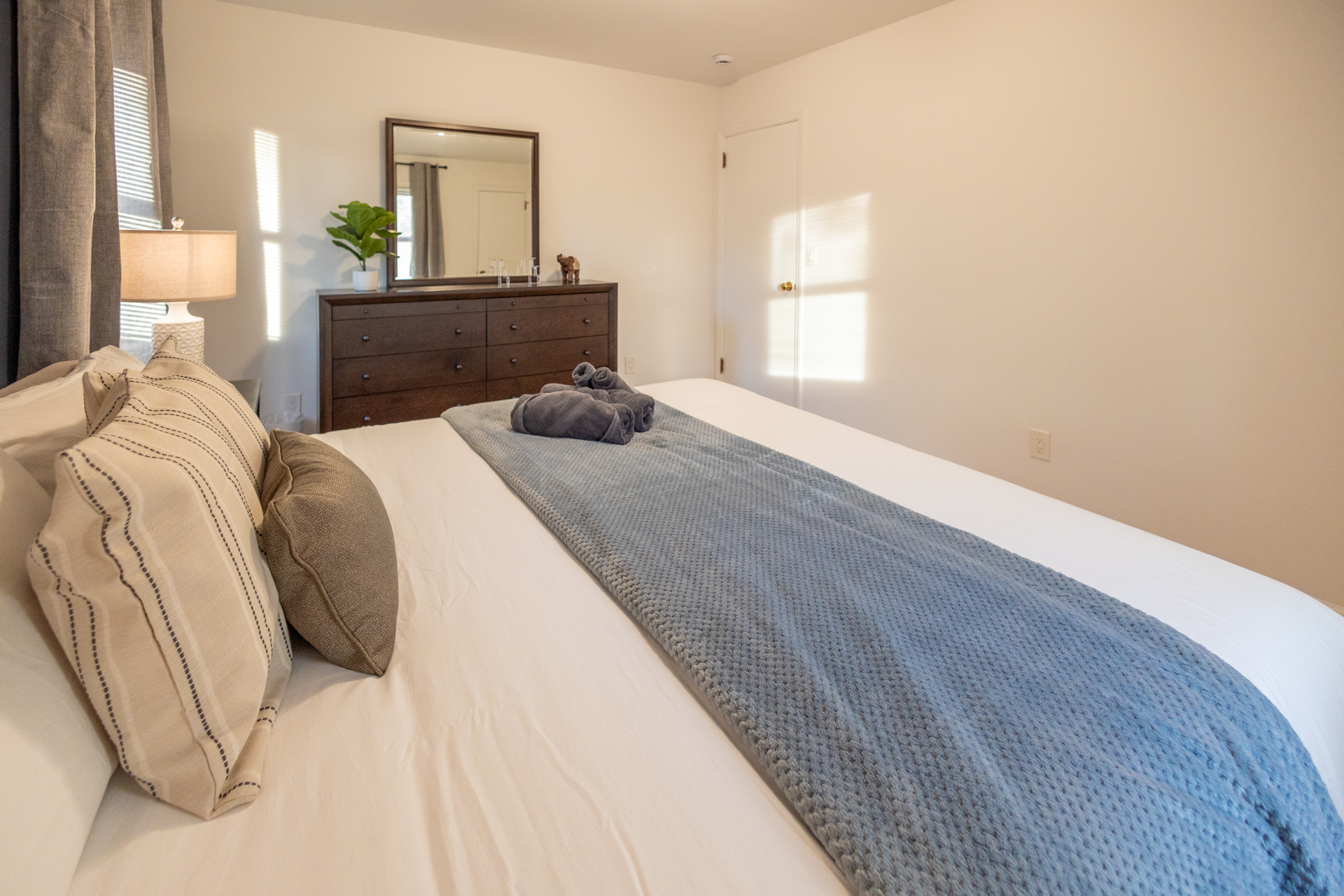 A tidy and inviting bedroom with natural light streaming in.
