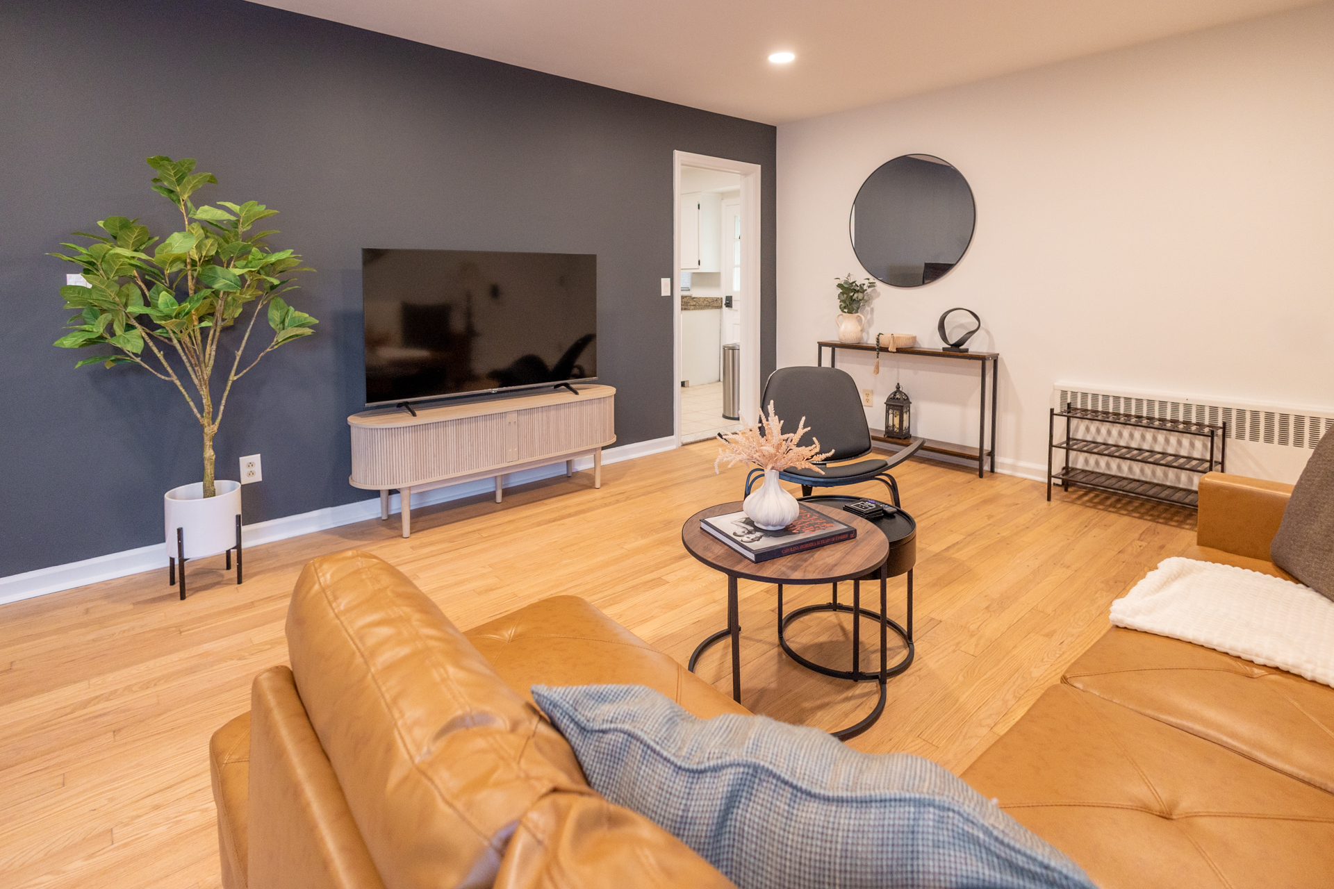 Bright living space with seating and television.