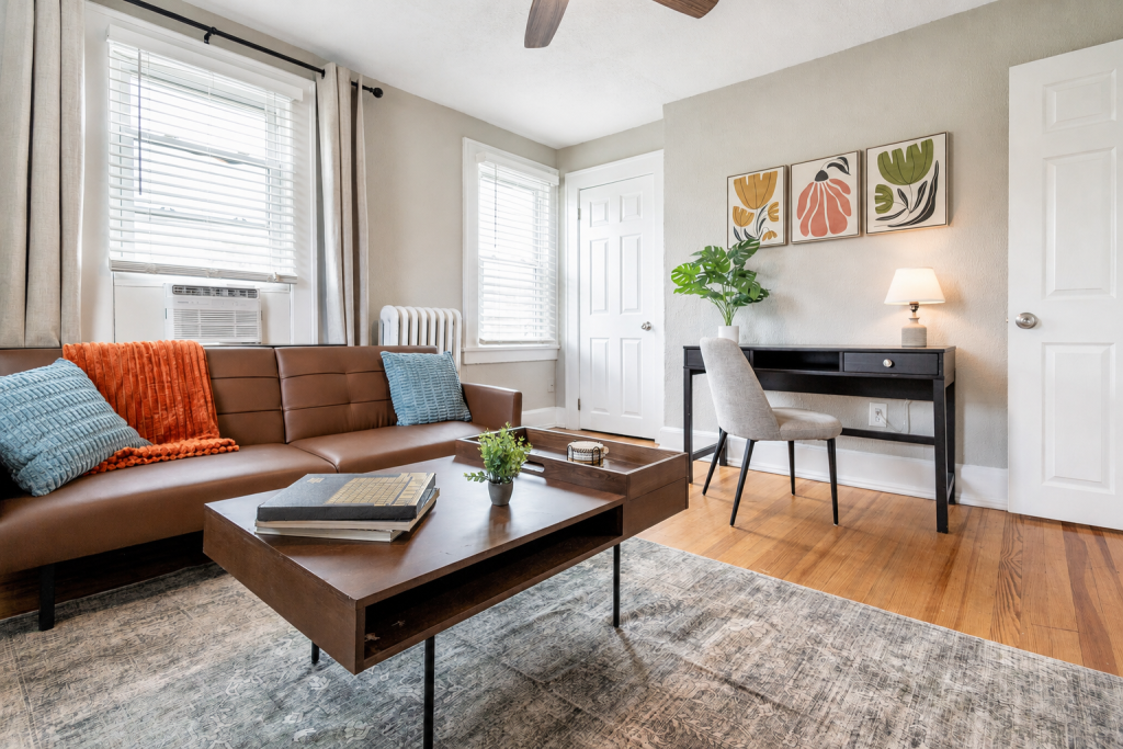 Cozy living room with a comfortable sofa, coffee table, and dedicated workspace