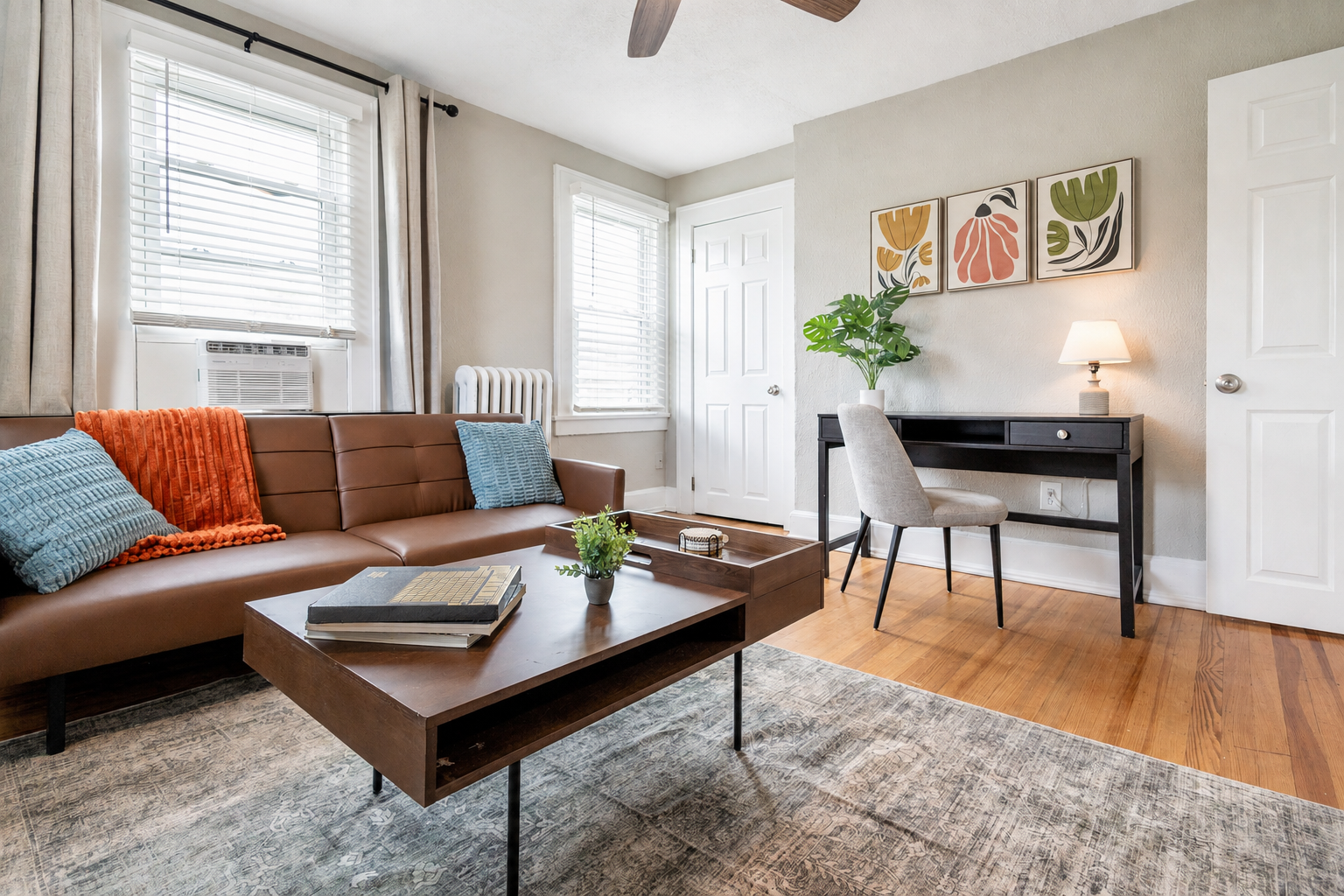 Cozy living room with a comfortable sofa, coffee table, and dedicated workspace